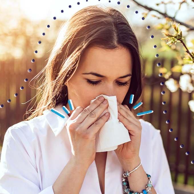 A person blowing their nose into a tissue