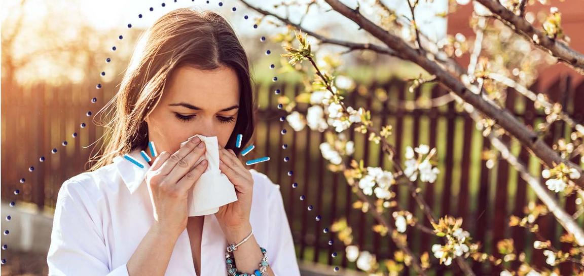 A person blowing their nose into a tissue