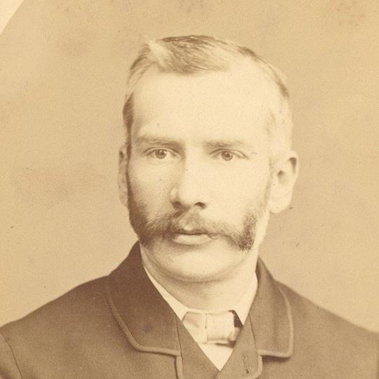 An historical image of a man with a moustache