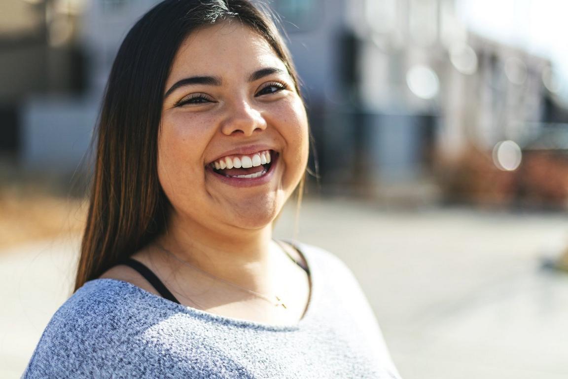 a young woman smiling in the outdoors
