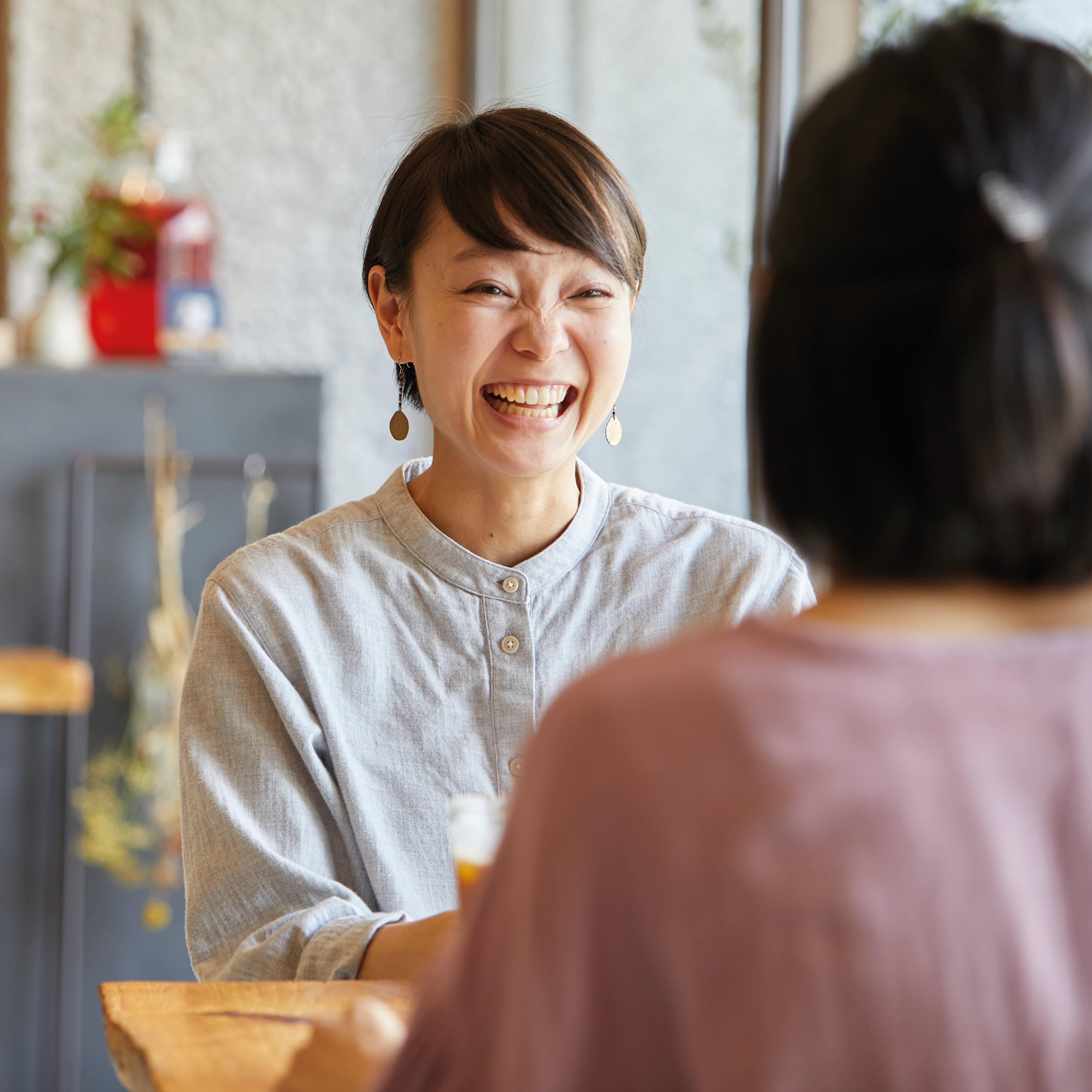 A person sat at a table smiling