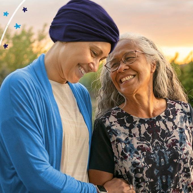 2 women walking hand in hand through trees