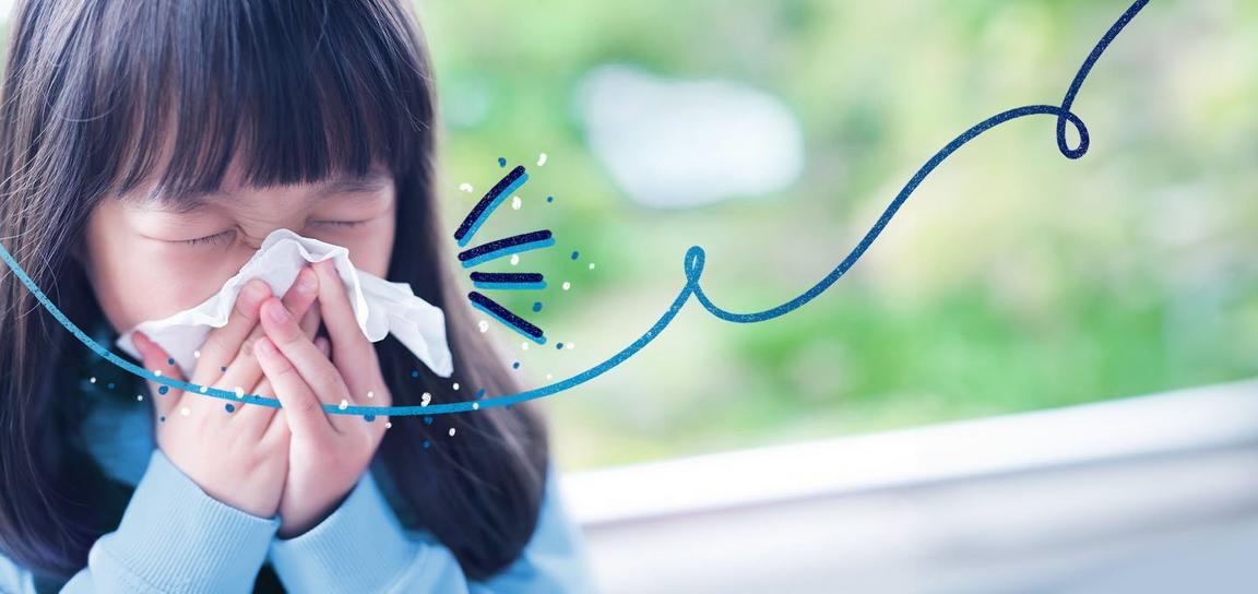 Someone sneezing into a tissue outside