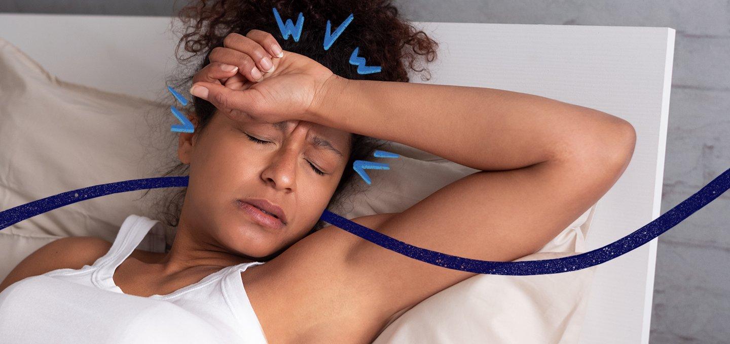 A person laying in bed with their arm over their forehead