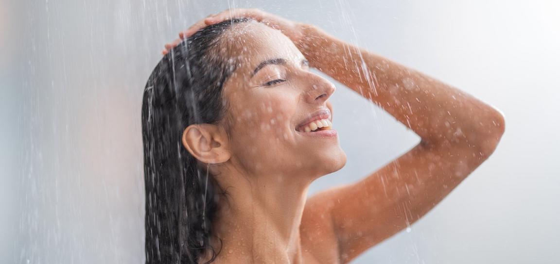 A person smiling in the shower
