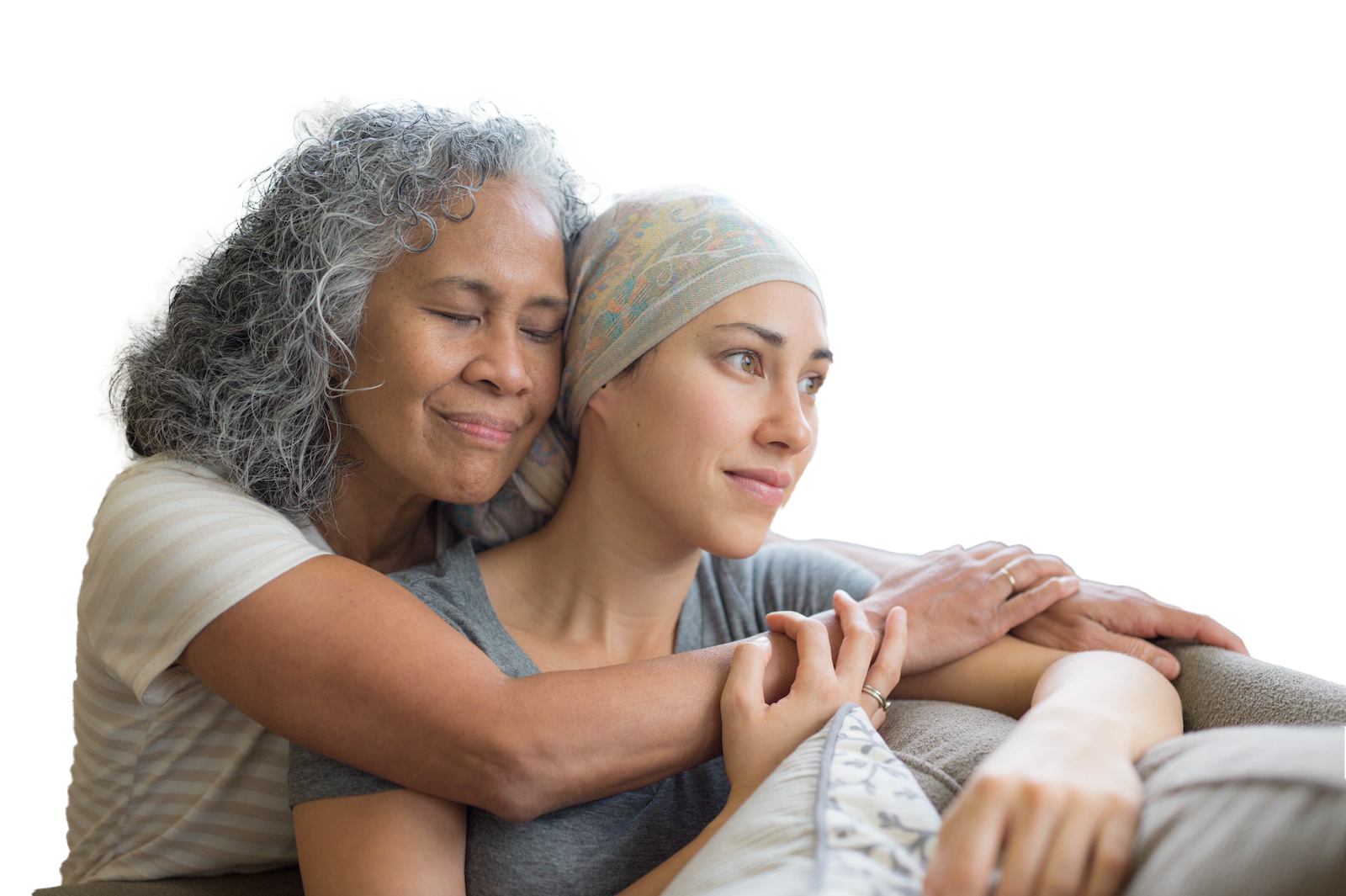 Someone smiling sat on a sofa with someone else leaning over their shoulders