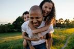A man giving two children a piggyback ride