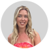 a person with long blonde hair in a red and orange floral top against a gray background