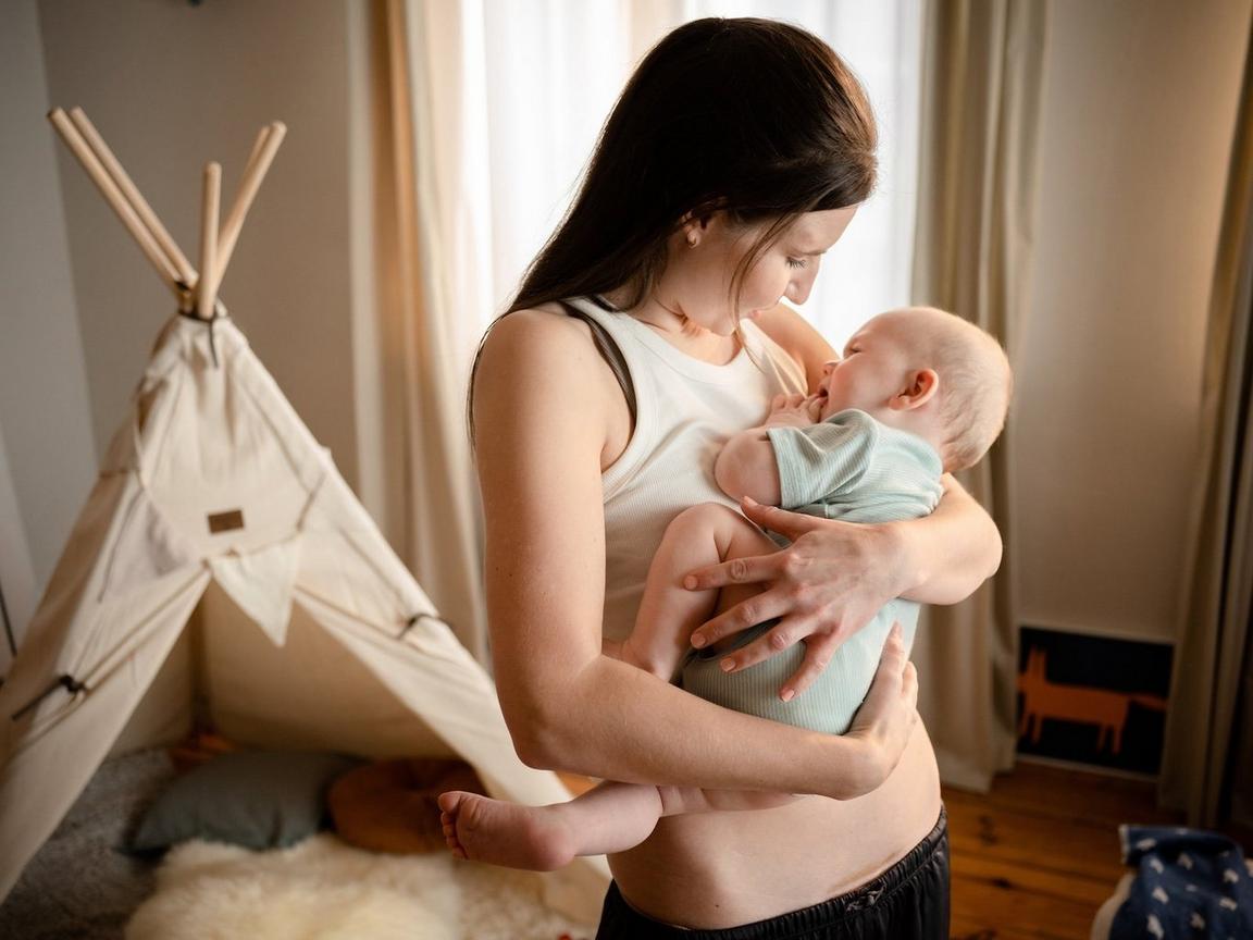 Somebody standing up holding a baby