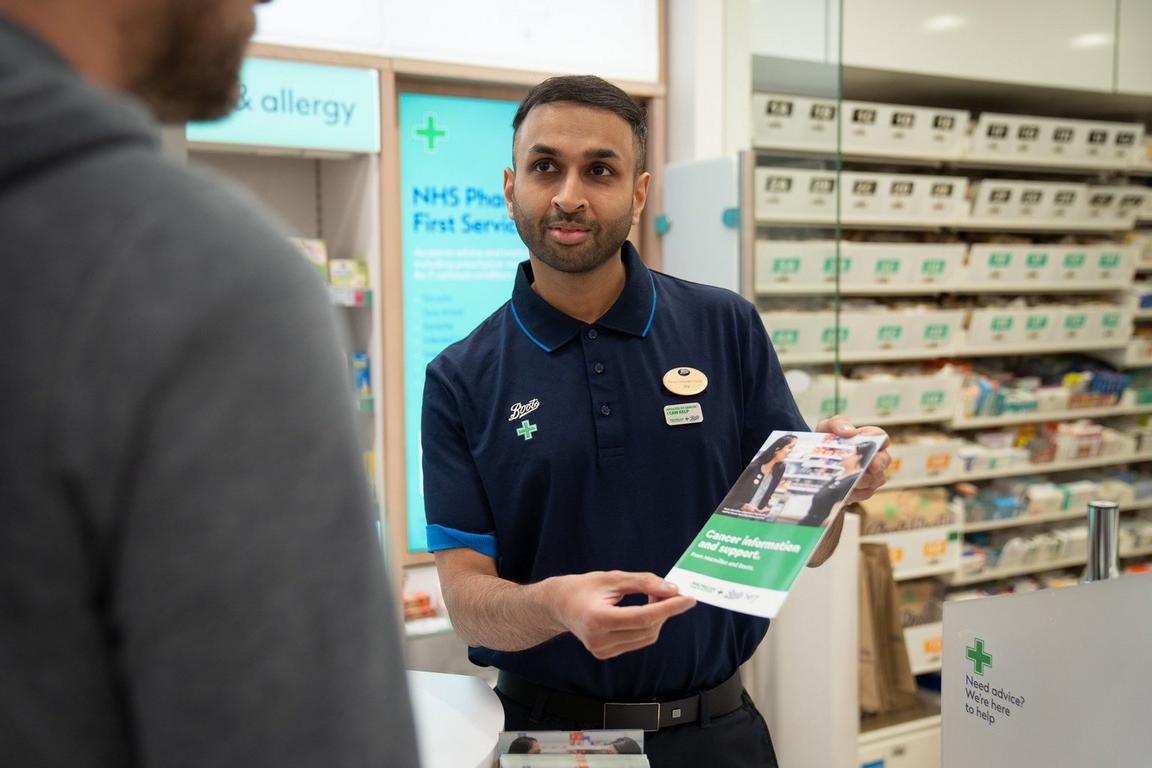 A smiling pharmacist stood in a Boots pharmacy