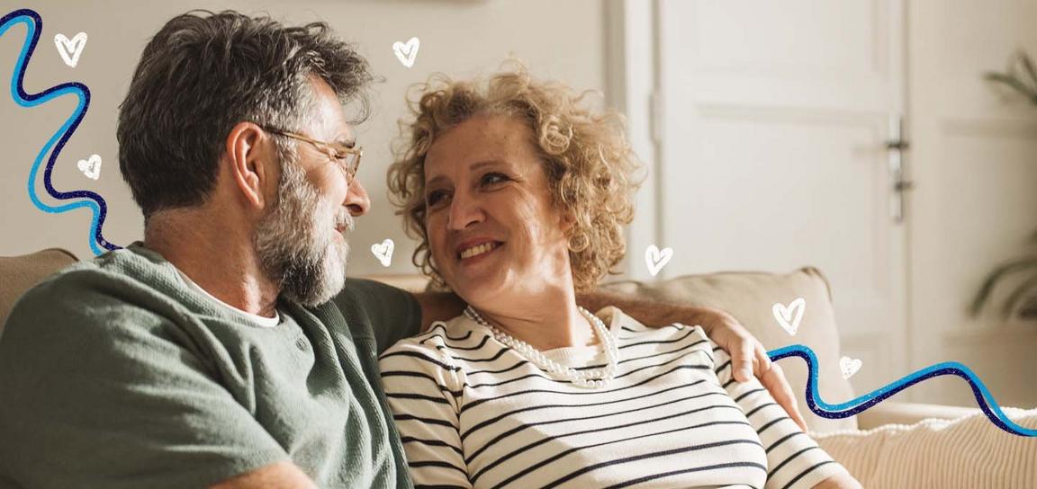 A man and a woman sat smiling at each other
