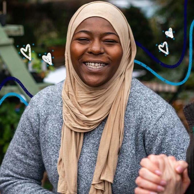 A group of people smiling and talking outside