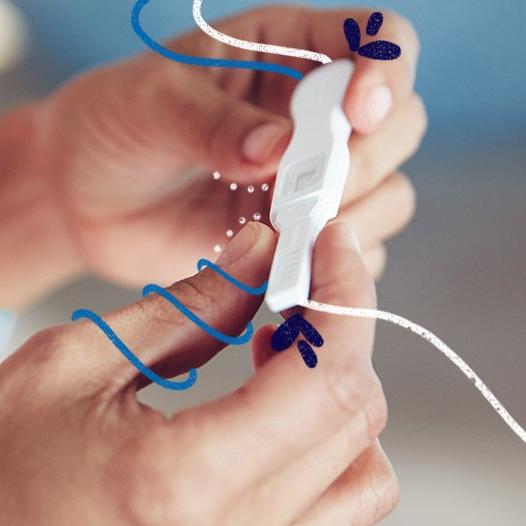 Someone holding an ovulation test