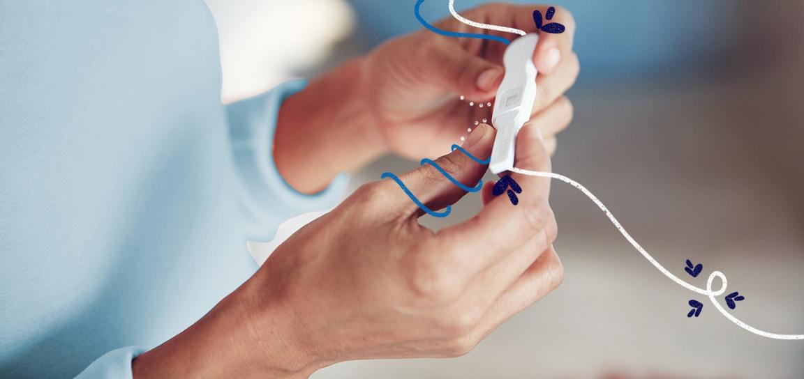 Someone holding an ovulation test