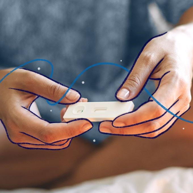 a white test pen being held in between 2 hands