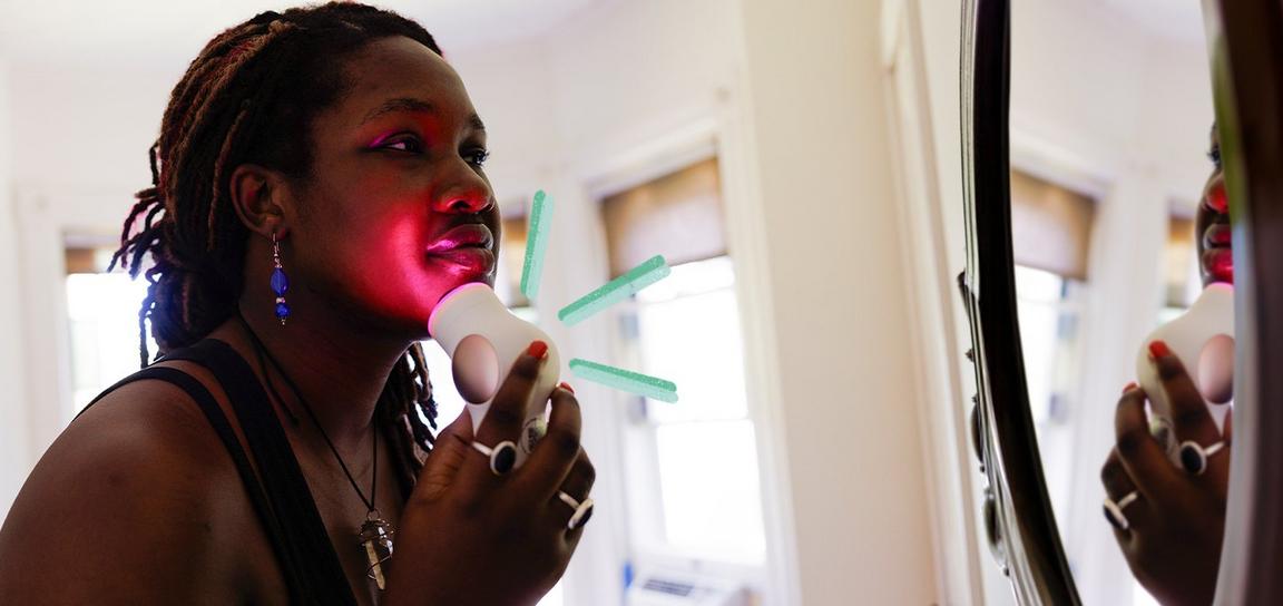 A woman outside, looking at her fitness tracker and smiling