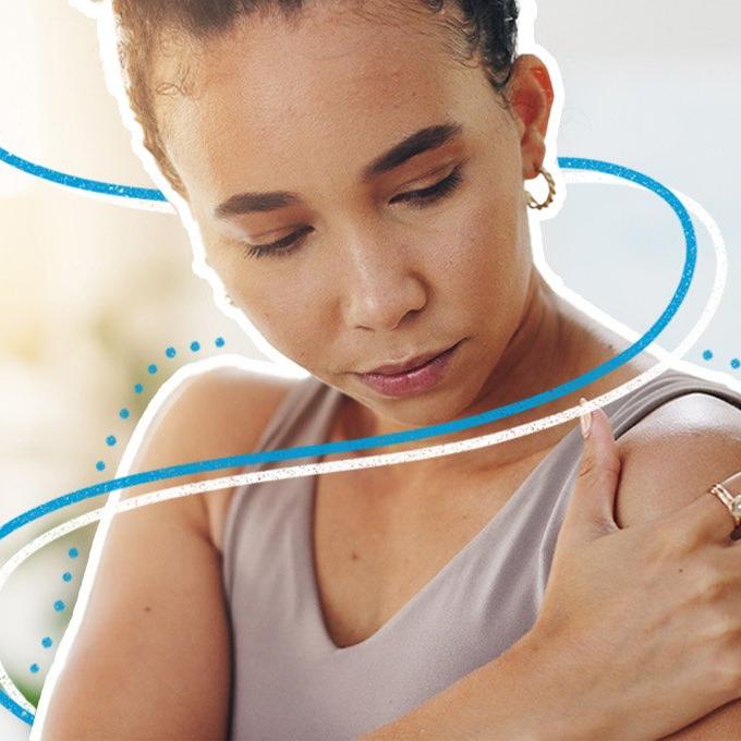 A woman holding her shoulder with blue and white lines around her