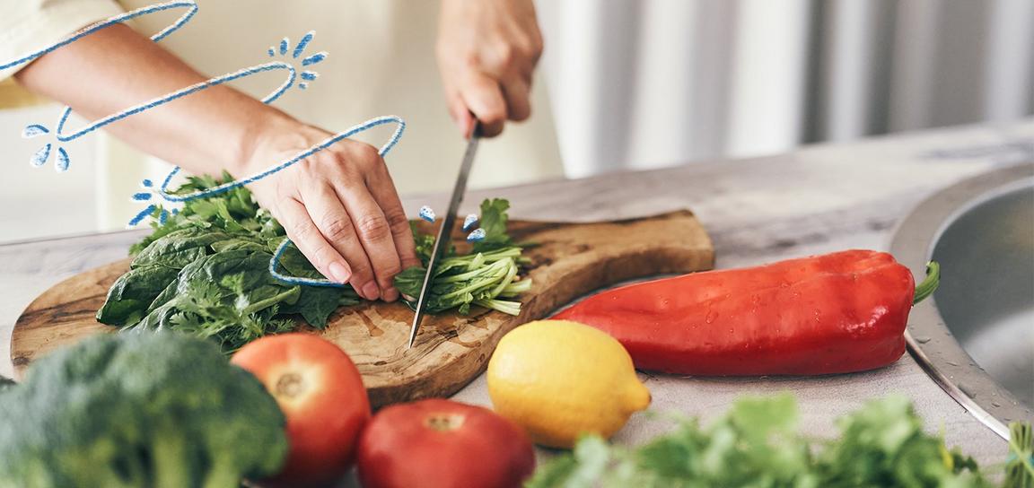 Somebody cutting up food on a chopping board
