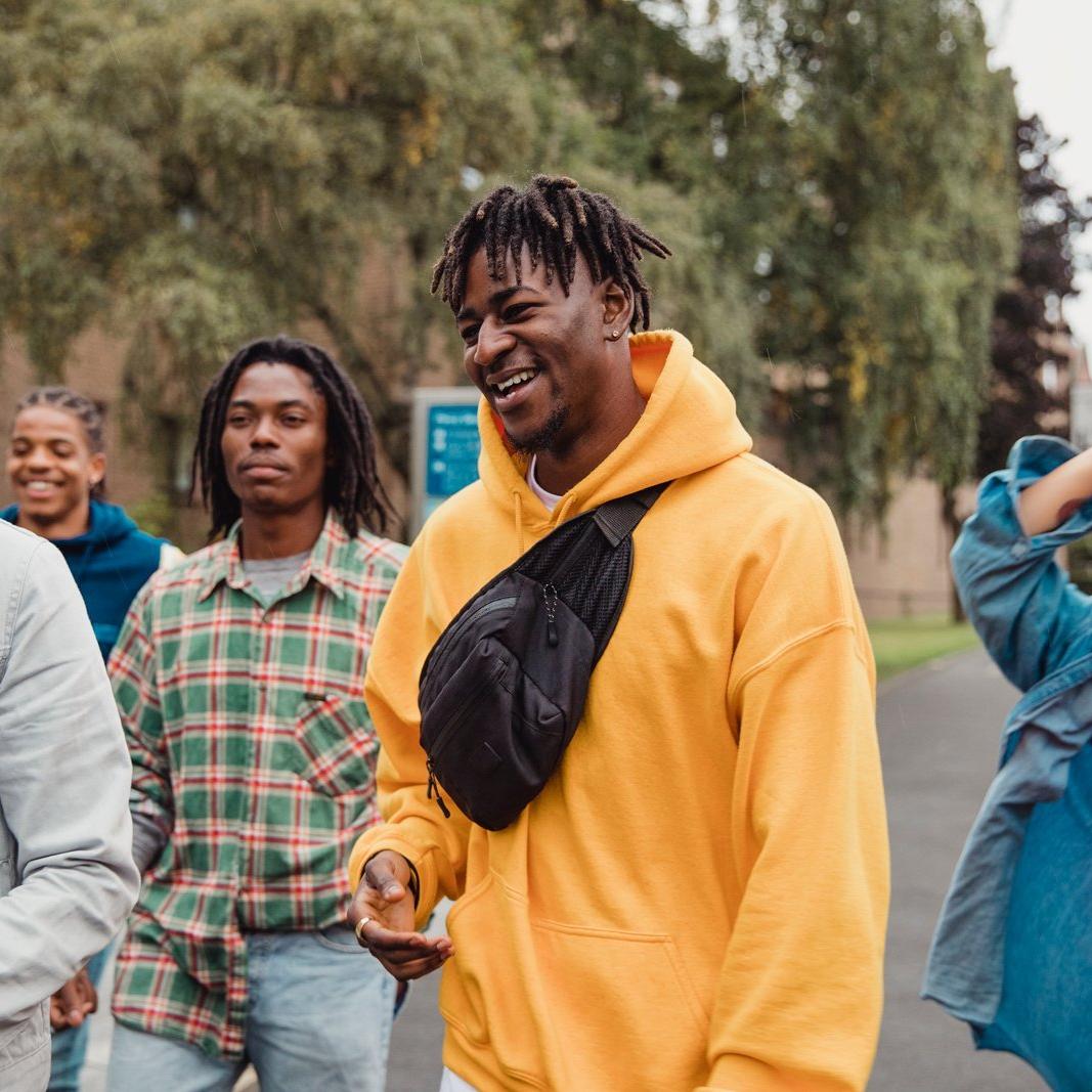 A group of people walking down the street