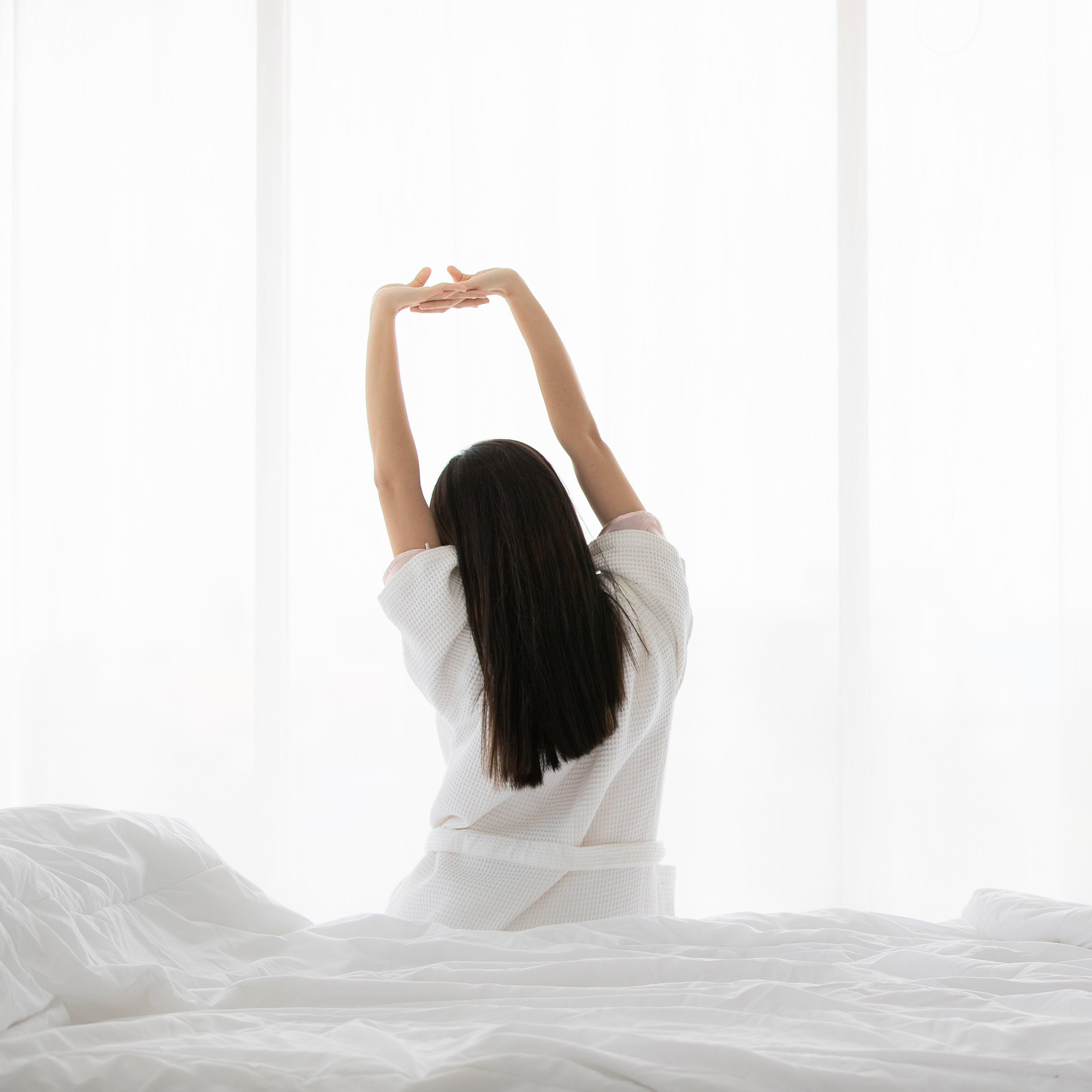 A person asleep in their bed