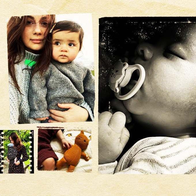 a lady with a baby sitting on her lap and a picture of a baby sleeping