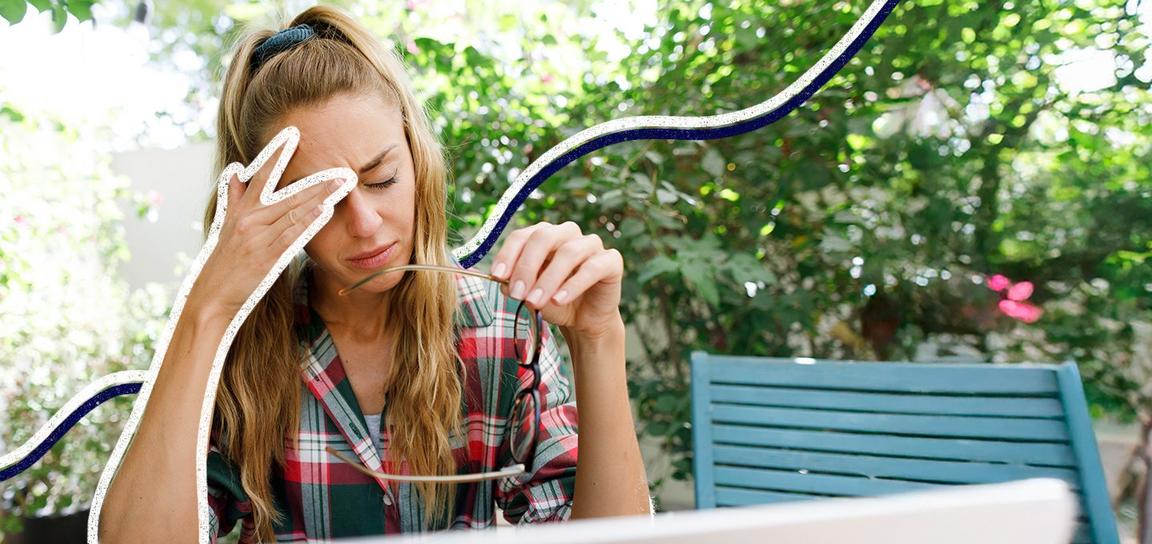 A woman outside, looking at her fitness tracker and smiling