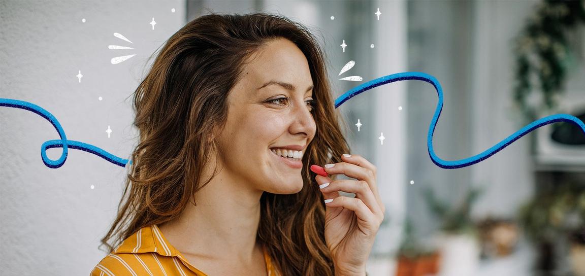 A woman smiling and holding a red pill, with decorative blue lines and sparkles around her.